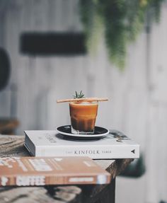 a book and a drink sitting on top of each other