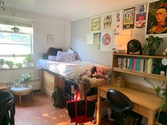 a bedroom with a bed, desk, and shelves filled with various items in it