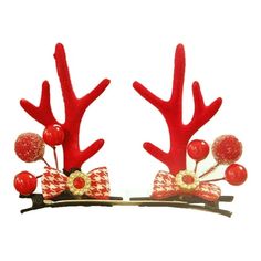 two red reindeer antlers with bows and candy on their heads are sitting next to each other