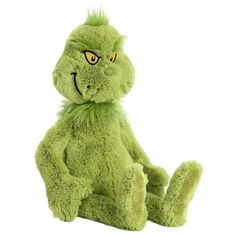 a green stuffed animal sitting on top of a white floor