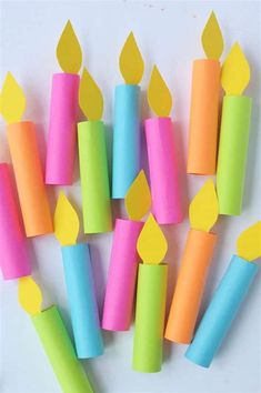 several different colored candles with yellow ones on them