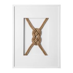 a white frame with a rope tied in the shape of a x on top of it