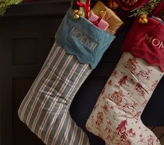 two christmas stockings hanging from a fireplace