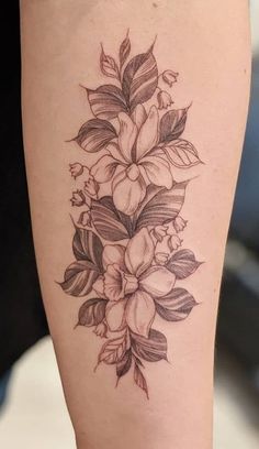 a black and white flower tattoo on the leg