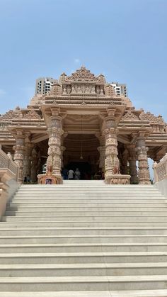 the stairs lead up to an elaborately decorated building