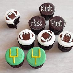 cupcakes decorated with football themed frosting are arranged on a wooden table top