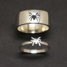 two different types of wedding rings with spider on them, one in silver and the other in white gold