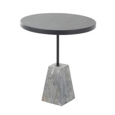 a round table with a black metal base and marble top, on a white background