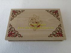 a wooden box with an ornate design on the front and sides, decorated with red flowers