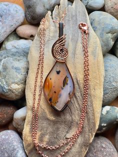 Montana agate with antique copper and black wire wrap Comes with 18" sterling plated chain shown in photos.  Pendant measures 2-1/4" x 3/4" Adjustable Wire Wrapped Agate Necklace, Hand Forged Agate Pendant Necklace, Wire Wrapped Copper Wire Teardrop Pendant Necklace, Wire Wrapped Agate Pendant Necklace, Hand-forged Agate Pendant Necklace, Hand Wrapped Carnelian Pendant Necklace, Wire Wrapped Agate Oval Pendant Necklace, Black Copper Wire Pendant Necklaces, Amber Agate Wire Wrapped Necklace