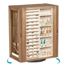 an open wooden jewelry cabinet filled with lots of different types of earrings and necklaces