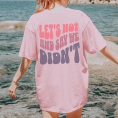 Make a bold statement with this oversized Comfort Colors 1717 garment-dyed t-shirt featuring the cheeky phrase "Let's Not and Say We Didn't" in trendy wavy letters across the back. Perfect for all the days you just can't be bothered, this tee is crafted from ultra-soft 100% ring-spun cotton and serves up serious comfort with an effortless, laid-back fit. From cozy winter layers to a breezy summer vibe, this shirt's got you covered in colors that match any mood. ️💅 Why You'll Love This T-Shirt: Oversized Acid Wash T-shirt With Text Print, Acid Wash Oversized T-shirt With Letter Print, Oversized Acid Wash T-shirt With Letter Print, Oversized Soft-washed Pink T-shirt, Acid Wash Short Sleeve T-shirt With Slogan, Sassy Personality, Wavy Letters, Wavy Font, Wavy Text