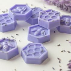 purple soaps with lavender flowers surrounding them