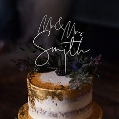 a white and gold wedding cake with the words ms & m's smith on top