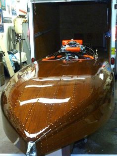 a wooden boat being worked on in a shop