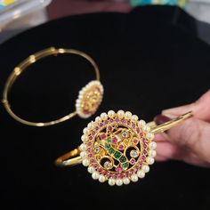 'Bajuband' or Armlet is a type of bracelet worn on the upper part of the arm. Armlets create a style statement for women in present times. Besides being wedding jewelry, armlets are also fashion jewelry. Armlets are the aptest accessory for weddings, engagements, theme parties, and religious occasions. Dainty armlets look beautiful when worn with lehengas, saris, or any sleeveless traditional attire. Stonework design (W x H): 1.5 x 1.5 inches. inner circumference : 8 inches Material: Bright gold Elegant Bracelets For Wedding And Navratri, Temple Jewelry Style Cuff Bracelet For Weddings, Elegant Bangle Bracelet For Navratri, Navratri Wedding Bracelet Jewelry, Temple Jewelry Bangle Bracelets For Party, Temple Jewelry Style Cuff Bracelet For Weddings And Festivals, Temple Jewelry Cuff Bracelet For Wedding And Festivals, Elegant Bracelets For Navratri Gift, Adjustable Temple Jewelry Bangle