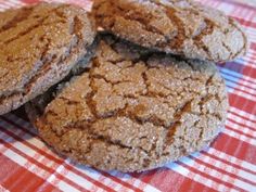 three cookies sitting on top of a red and white checkered table cloth