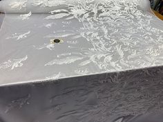 a table covered with white lace on top of it