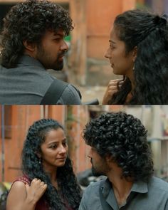 a man and woman standing next to each other in front of a building with long curly hair