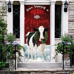 a cow standing in front of a red door with merry written on it's side