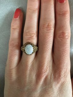 A beautiful chunky vintage ring. Made from 9ct solid yellow gold with an oval fiery opal and unusual textural engraving. It would make an elegant engagement ring.  Size UK L 1/2 US 6 EU 51 Diameter 16.5mm In great vintage condition. x Oval Gold Opal Ring In 14k Gold, Heirloom Gold Opal Ring With Cabochon, Heirloom Gold Opal Cabochon Ring, Antique Gold Opal Ring Collectible, Collectible Gold Opal Ring With Gemstone, Antique Oval Moonstone Ring Collectible, Vintage Gold Opal Jewelry, Collectible Gold Opal Gemstone Ring, Vintage Opal Ring As A Gift