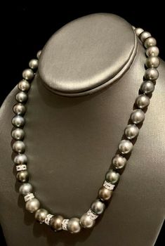 Diamond Tahitian Pearl Necklace 18k Gold 12.9 mm 18" Certified $12,250 821384 This fine piece of jewelry is designed by Ezra Kassin! DETAILS 14 KT SOLID WHITE GOLD RONDELS 18 KT SOLID WHITE GOLD CLASP (Clasp Stamped 750) 12.90-10.00 IN 75.809 Grams Total Weight Quality Grade: AA (High) Color: Gray Overtone: Silver & Peacock Surface: Lightly Blemished Luster: High 39 Large GrayTahitian Pearls 72 Single Cut Diamonds The Gray Tahitian Pearls Have A Silver & Peacock Overtone What a glamorous Luxury Tahitian Pearl Jewelry With Brilliant Cut, Luxury Tahitian Pearl Jewelry With Diamond Accents, Akoya Pearl Earrings, Diamonds And Pearls, Tahitian Pearl Necklace, Pearl And Diamond Necklace, Alumni Association, Akoya Pearls, Tahitian Pearls