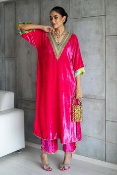 Hot pink velvet kaftan with contrast yoke, zari, sequin, bead and multi color resham hand embroidery. Paired with contrast hot pink hand embroidered bordered palazzo. - Aza Fashions Bollywood Style Velvet Dress For Eid, Bollywood Velvet Dress For Eid, Party Velvet Kurta With Mirror Work, Velvet Party Dress For Diwali, Anarkali Style Sequined Kaftan For Party, Velvet Dresses For Eid, Velvet Dress For Diwali, Velvet Kaftan, Fashion App