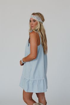 So comfortable, cute, and effortless, the Swing Of Things Denim Dress is perfect for all - day wear. Whether you're running errands or catching up with friends, you'll look and feel great! Flowy, mineral washed stretch cotton fabric Relaxed and loose mini dress silhouette Gathered scoop neckline and open scoop backline So CUTE shoulder tie detail with bows (shoulder tie is not adjustable) Ruffled bottom hem with raw detailing adds a playful touch Pair with: Floral Cut Out High Neck Bralette, Gre Washed Blue Chambray Denim Dress For Day Out, Light Wash Chambray Dress For Day Out, Light Wash Chambray Denim Dress For Day Out, Blue Tencel Denim Top For Summer, Spring Light Wash Tencel Denim Top, Light Wash Tencel Denim Top For Spring, Spring Medium Wash Chambray Denim Dress, Spring Chambray Denim Dress In Medium Wash, Light Wash Chambray Denim Dress