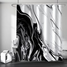 a black and white marble shower curtain in a modern bathroom with toiletries on the floor