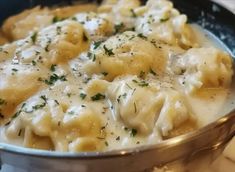 a pot filled with pasta and cheese covered in sauce