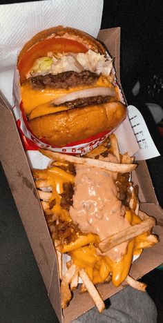 a cheeseburger and fries are sitting in a box