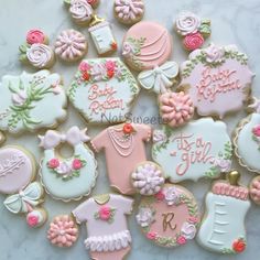 decorated baby shower cookies arranged on a table