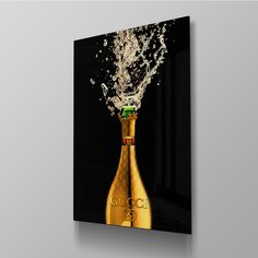 a gold bottle with water splashing out of it