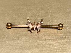 "Cute sparkling center stone butterfly industrial barbell. Barbell Length: 1-1/2\" (38MM) Barbell Thickness: 14G Made with high quality surgical steel. Price is for each." Rose Gold Industrial Piercing, Industrial Bars Piercings, Industrial Piercing Jewelry Butterfly, Gold Industrial Piercing Bar, Clear Industrial Piercing Bar, Industrial Bar Piercing, Industrial Ring, Industrial Bar Earring, Conch Stud