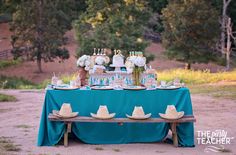 the table is set with hats and desserts