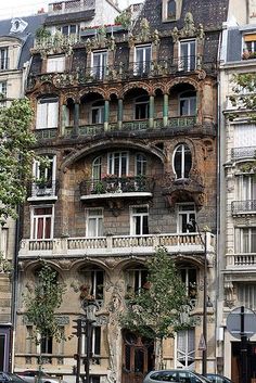 an old building with many windows and balconies on the top floor in paris