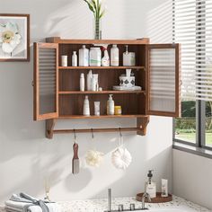 a wooden cabinet above a sink filled with personal care items