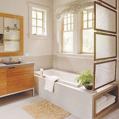 a bath room with a tub a sink and a mirror on the wall next to a window