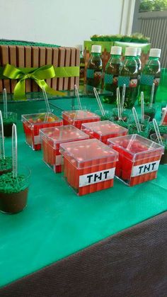 there are many containers on the table that have plants in them and some straw sticks sticking out of them