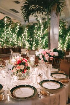 the table is set with white plates and silverware