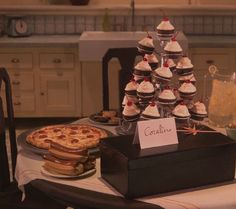 a table topped with cupcakes and desserts