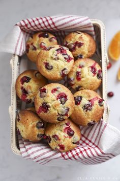 fresh blueberry muffins in a basket with a red and white checkered napkin