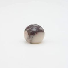 a marble ball sitting on top of a white surface