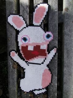 a close up of a piece of art made to look like a rabbit on a fence