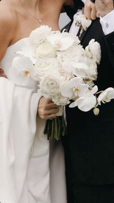 the bride and groom are kissing each other