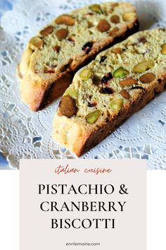 two slices of pistachio and cranberry biscotti bread on a lace doily