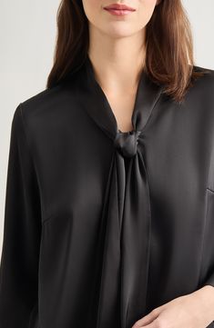 This tie-neck blouse made from  lightweight crêpe de chine is a perfect workday option. Ties at neck Long sleeves 100% polyester Hand wash, line dry Imported Bow Neck Blouse Designs, Blouse With Neck Tie, Workwear V-neck Blouse With Tie Sleeves, Elegant Tie Neck Blouse For Daywear, Chic Blouse With Tie Sleeves And Neck, Silk Tie Neck Blouse For Daywear, Black Silk Tops For Daywear, Chic Silk Tie Neck Blouse, Classic Silk Blouse With Tie Neck