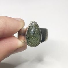 This genuine moldavite ring weighs 8.5 grams and is a size US 7.75. This rare stone sits in all sterling silver, the front is faceted and the back is raw. Our Moldavite is guaranteed 100% genuine from the Czech Republic. Moldavite comes from a meteor collision with Earth almost 15 million years ago. Found only in the Czech Republic these green Gems are one of the most rare minerals on Earth. This tektite is composed of natural glass and is created when a meteorite collides with earth resulting i Crystals For Manifestation, Moldavite Jewelry, Rare Stone, Green Gems, Birthstone Jewelry, Photo Jewelry, Gemstone Jewelry, Statement Rings, Jewelry Rings