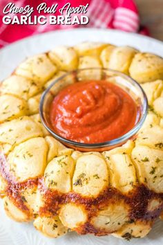 an appetizer on a plate with sauce in the middle and bread crusts around it