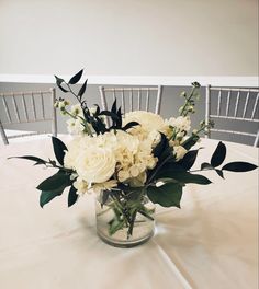 a vase filled with white flowers on top of a table